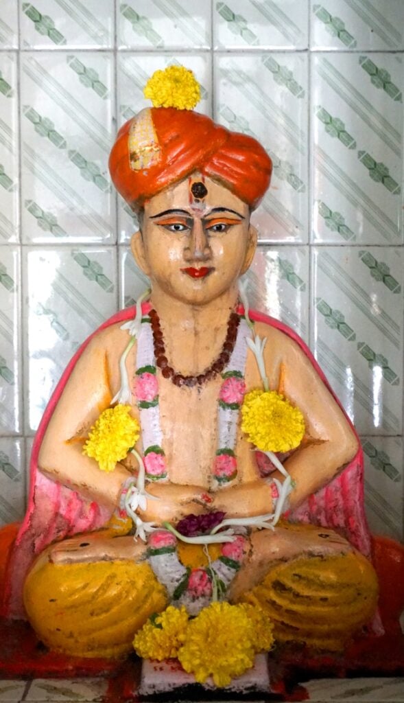 मंदिरात हार घालून सजवलेली संत ज्ञानेश्वरांची मूर्ती.